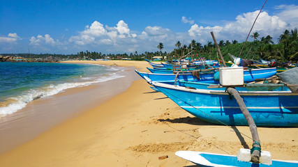 Fishing wooden boats by the ocean a