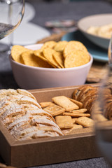 Different bread toast slices on a wooden box on a prepared and served food table on a restaurant