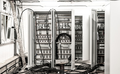 Relay hall with a variety of wires in the process of installation
