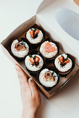 Cupcakes with strawberries and heart. Holiday cupcakes in box, dessert decoration. Gift for Valentine's Day.