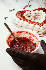 Cooking cake heart, decoration with cranberry jam, valentines day concept.