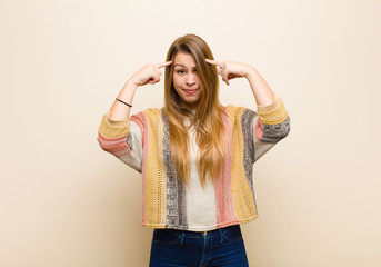 young blonde woman with a serious and concentrated look, brainstorming and thinking about a...
