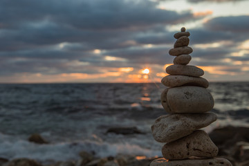Zen concept. Sunset. The object of the stones on the beach at sunset.  Relax & Meditation. Zen stones. Golden hour