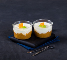 Vanilla Panna cotta in a Cup, Italian dessert creamy jelly with a tangerine layer, decorated with...