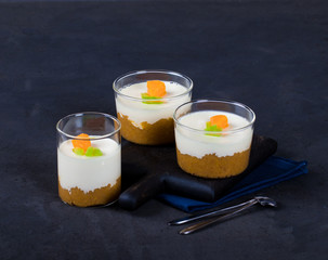 Vanilla Panna cotta in a Cup, Italian dessert creamy jelly with a tangerine layer, decorated with...