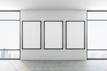 Minimalistic gallery interior with three posters on wall