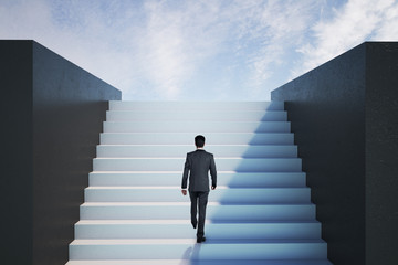 Businessman walking on ladder to success