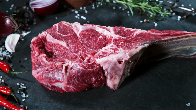 Flying piece of raw beef tomahawk steak. Filmed on high speed cinema camera, 1000 fps.