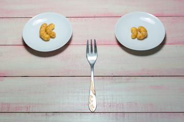 Corn snacks in a small plate and fork.