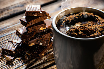 cup cacao with chocolate in the background close up