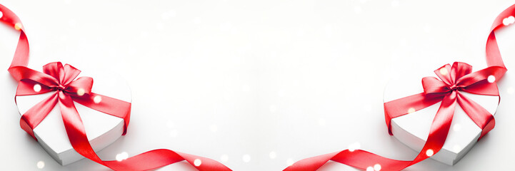 Valentines day background. White gift box with bow and red ribbon heart, photo template, background. Top View.