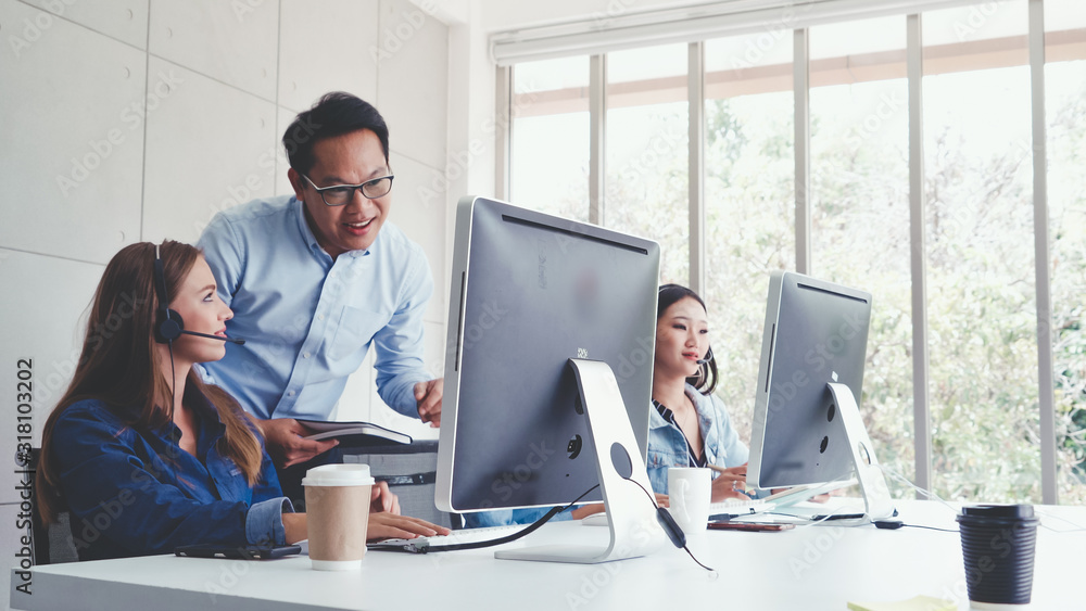 Aufkleber customer support agent or call center with headset works on desktop computer while supporting the cu