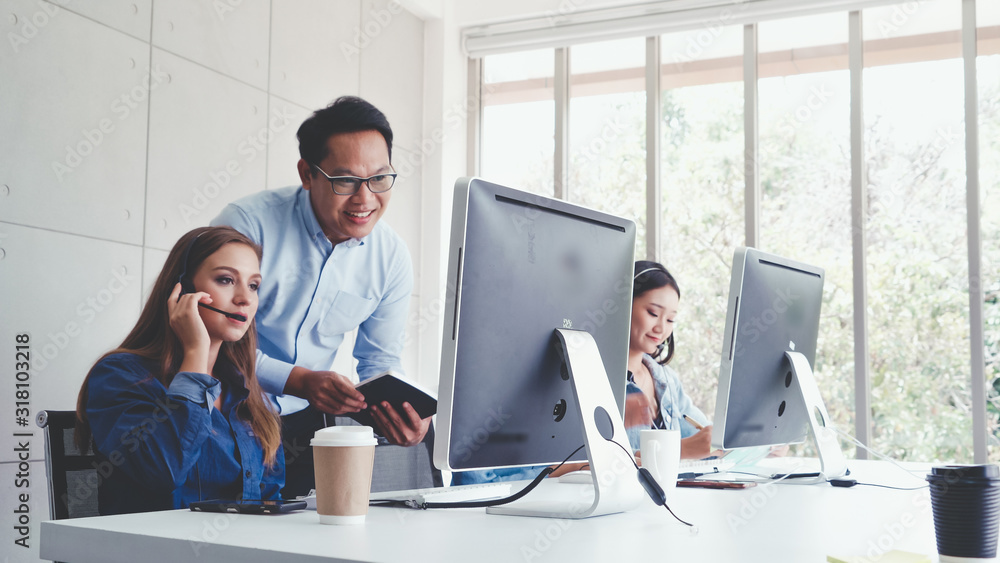Aufkleber customer support agent or call center with headset works on desktop computer while supporting the cu