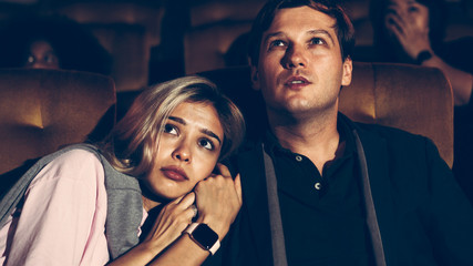 People audience watching movie in the movie theater cinema. Group recreation activity and...