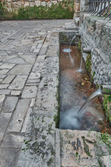 Natural spring water, where fresh and pure water comes from. Concept: nature, purification, freshness. San Juan Fountain. Jewel of Visigoth art. Declared of Cultural Interest in Baños de Cerrato, Pale