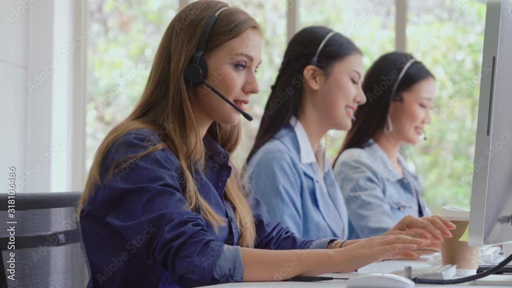 Aufkleber customer support agent or call center with headset works on desktop computer while supporting the cu