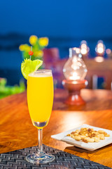 Delicious food and drink on wooden table with candle in restaurant