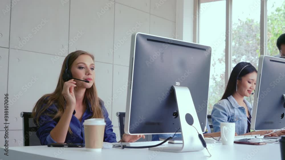 Aufkleber customer support agent or call center with headset works on desktop computer while supporting the cu