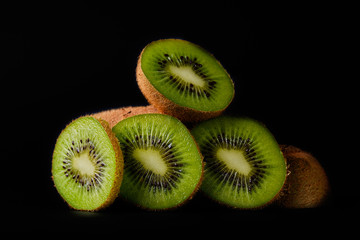 Sliced kiwi on a black background close-up