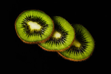 Sliced kiwi on a black background close-up