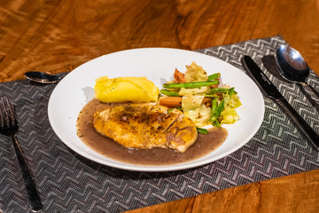 Delicious food and drink on wooden table with candle in restaurant