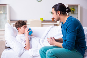 Young father caring for sick son