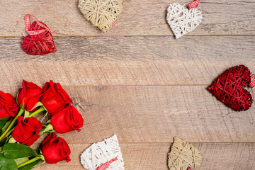 Red and white hearts with roses on wooden background