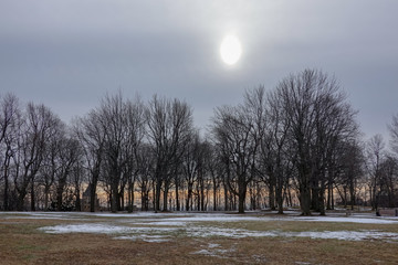 huge sun in the sky melting winter's snow ground