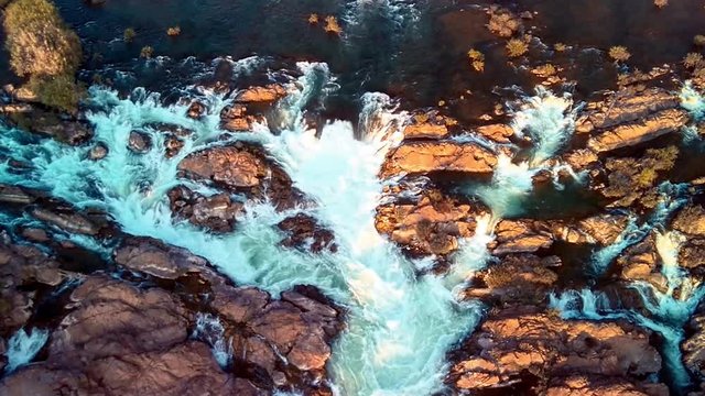 Khone Falls, series of cascading waterfalls and rapids over the Mekong river on Laos and Cambodia border panoramic aerial sunset view. Don Khon island, Four thousand islands area.