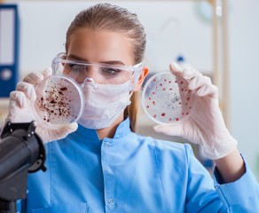 Female scientist researcher conducting an experiment in a labora