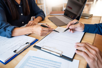 Young students classmates help friend catching up workbook and learning tutoring in a library, education and school concept