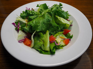 Salad plate of lettuce leaves and sliced tomatoes