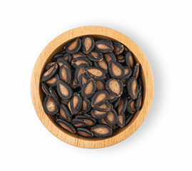 Watermelon seeds in a wooden cup on a white background Top view