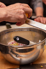 Sushi roll being sliced in a demonstaration class