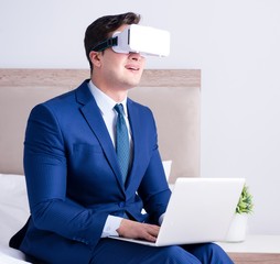 Businessman wearing a virtual reality headset in the bedroom