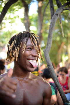 Shirtless Man Smiling While Gesturing Against Trees