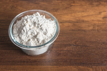 White four in glass bowl on wood texture table top with copy space.
