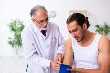 Fototapeta premium Young male patient visiting experienced doctor