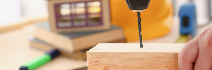 Arms of worker using electric drill closeup. Manual job DIY inspiration improvement job fix shop yellow helmet joinery startup idea industrial education profession career concept