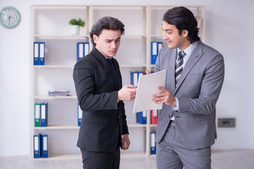 Two young businessmen meeting in the office