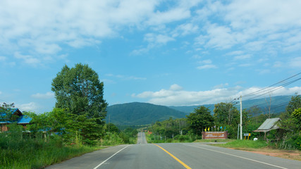 Rural asphalt road amidst trees