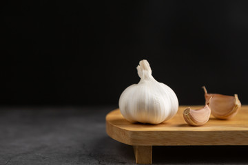 Garlic on the black table and black background.