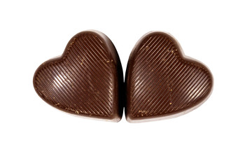 Two heart shaped chocolate candies isolated on white background