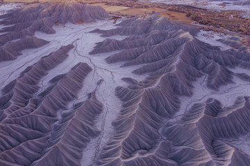 cinematic aerial drone shot of dramatic desert badlands landscape