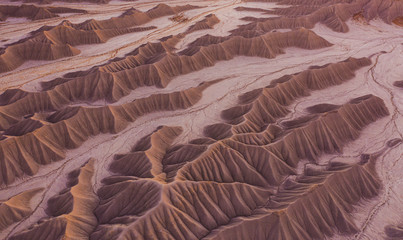 aerial drone perspective of barren alien desert badlands