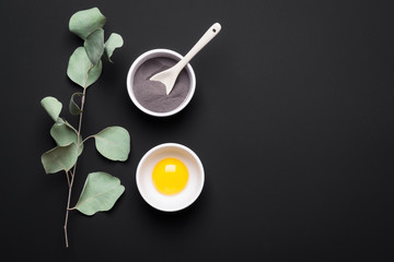 Natural ingredients clay, yolk and eucalyptus for homemade beauty cosmetic products. DIY cosmetics and spa concept