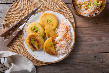 Salvadoran pupusa served with curtido  on board. view from above