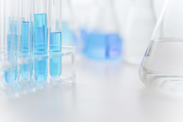Laboratory equipment for chemical experiment consists of test tube in rack, erlenmeyer flasks and...