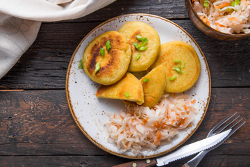 Salvadoran pupusa served with curtido  on board. view from above