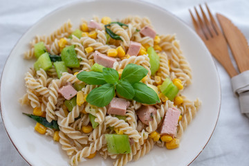 healthy italian pasta salad with corn, vegetables and ham